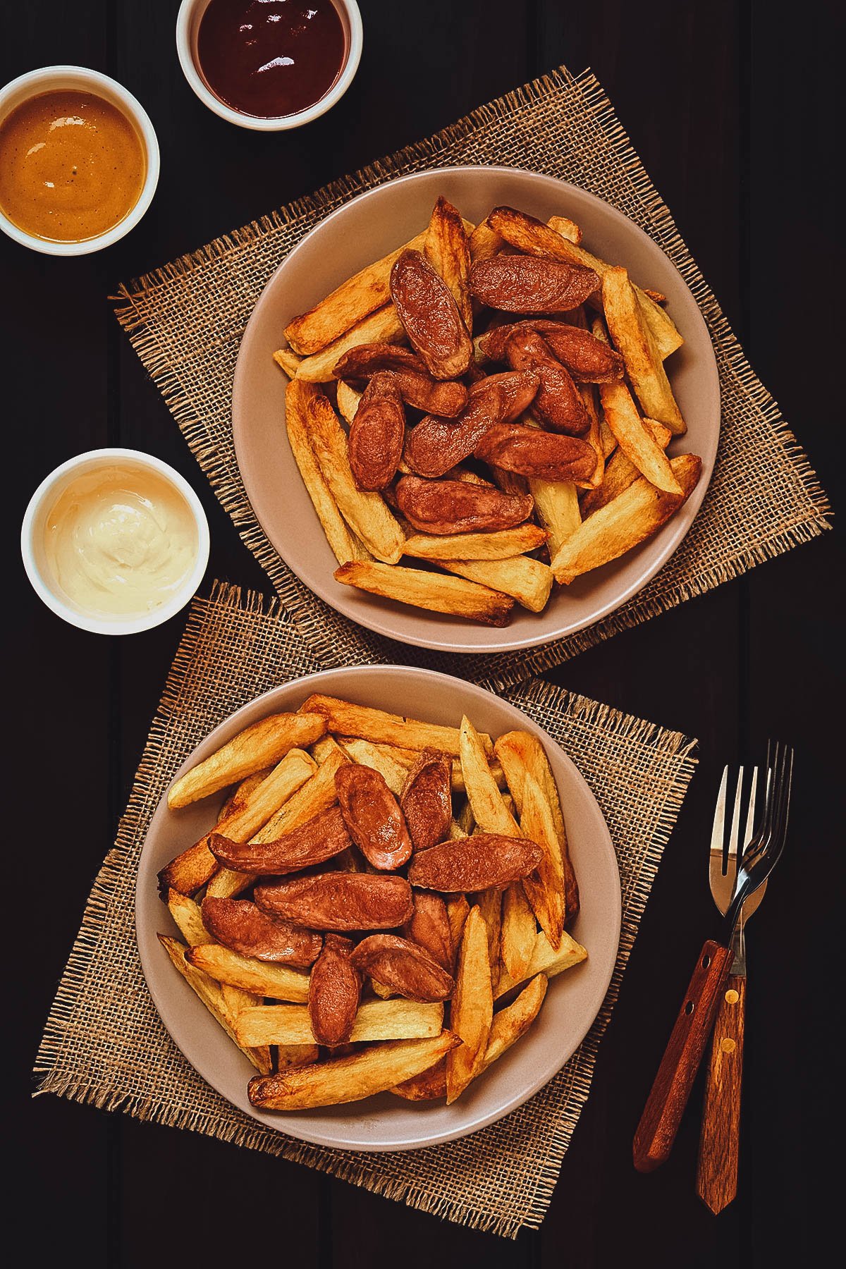 Plates of salchipapas, a popular street food dish made with sausages and french fries