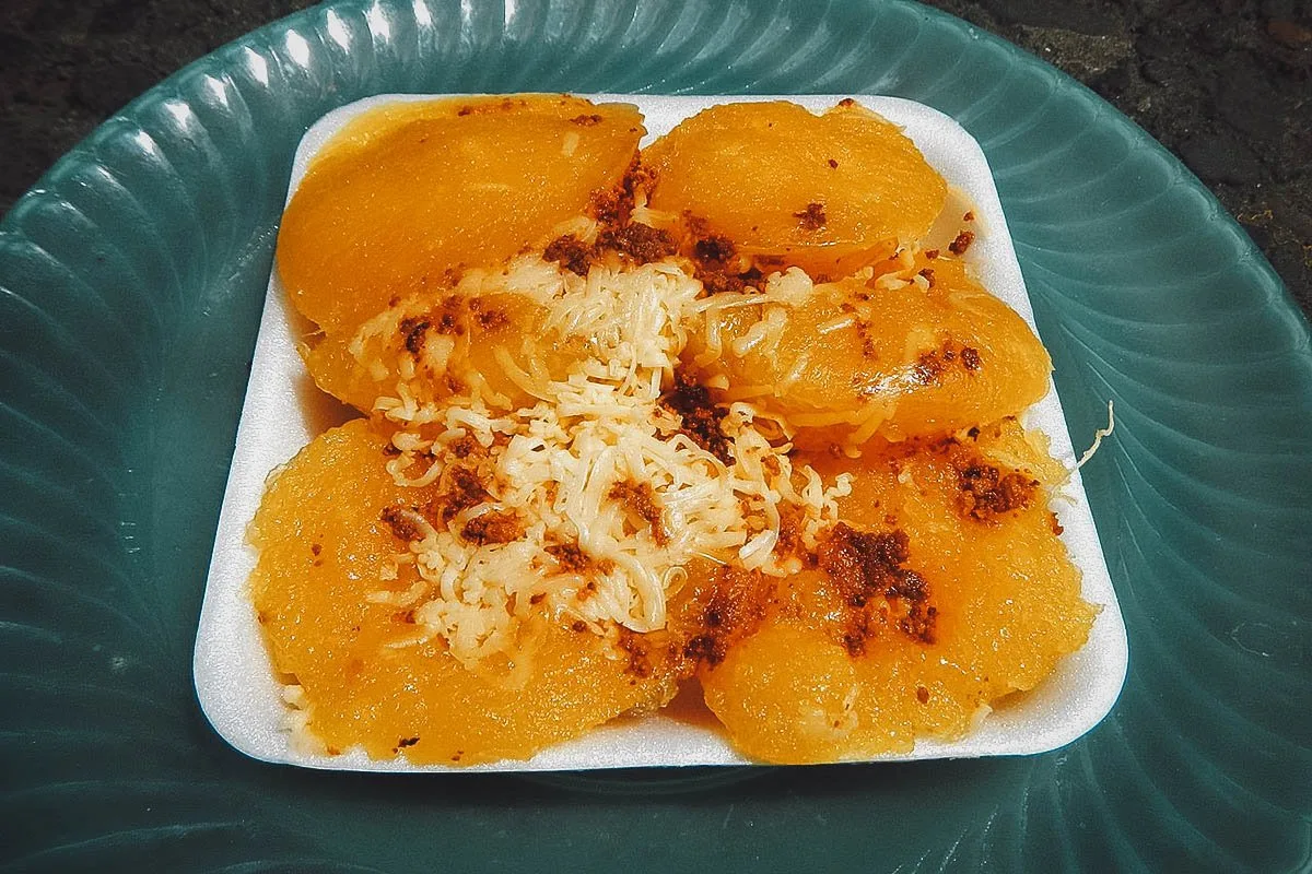 Filipino Desserts Pichi-pichi, a type of Filipino cassava cake topped with cheese and toasted coconut curd