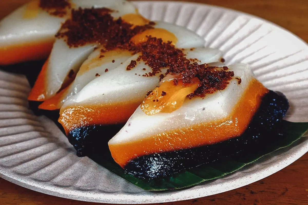 Filipino Desserts Sapin-sapin, colorful layered Filipino rice cake topped with toasted desiccated coconut