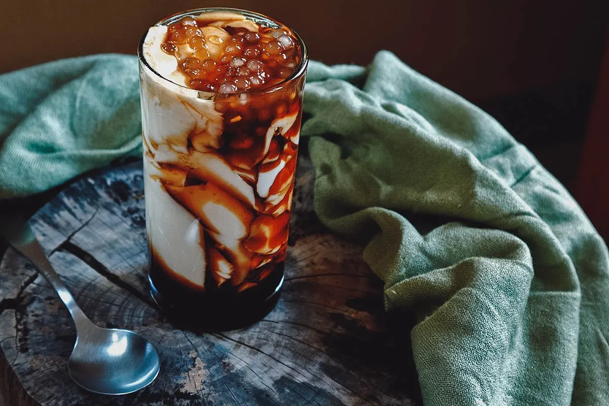 Filipino Desserts Glass of taho, a popular Filipino dessert of silken tofu with sago and brown sugar syrup