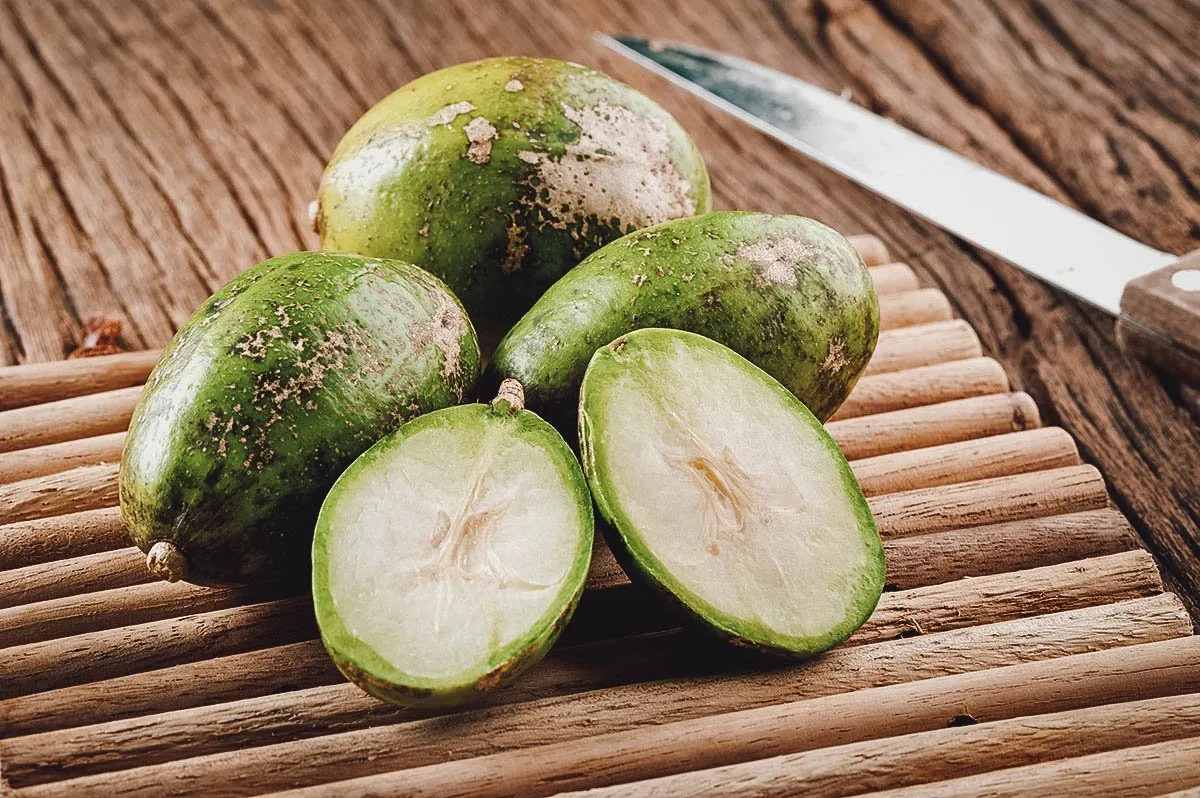 Hog plums sliced on a table