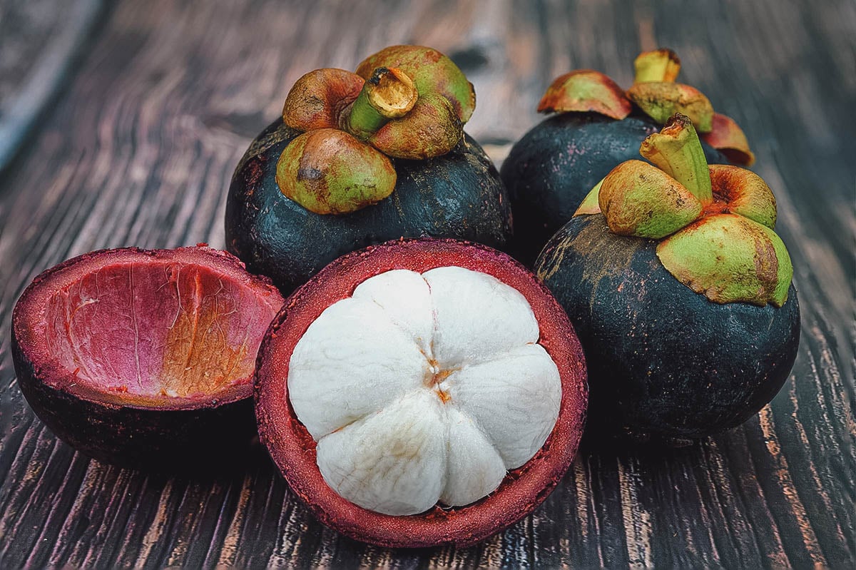 Mangosteen with segments of soft white flesh