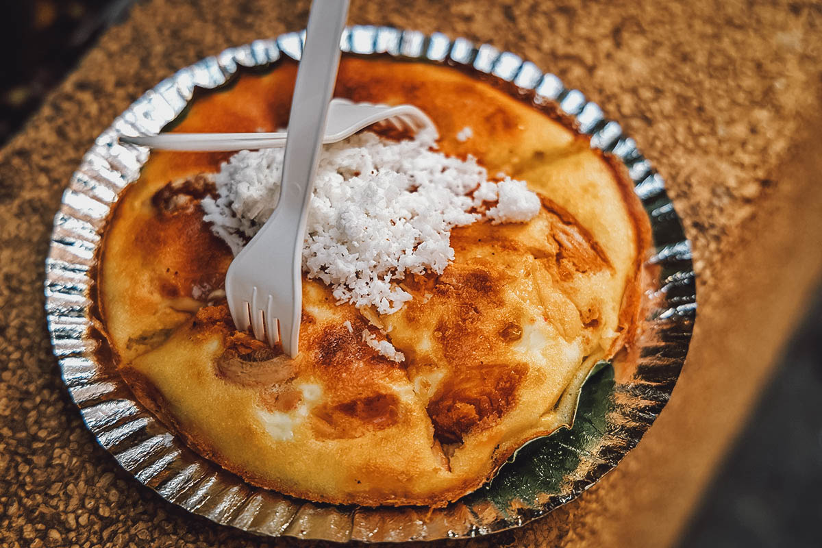 Serving of bibingka, Filipino sticky rice cake made with salted egg and topped with grated coconut