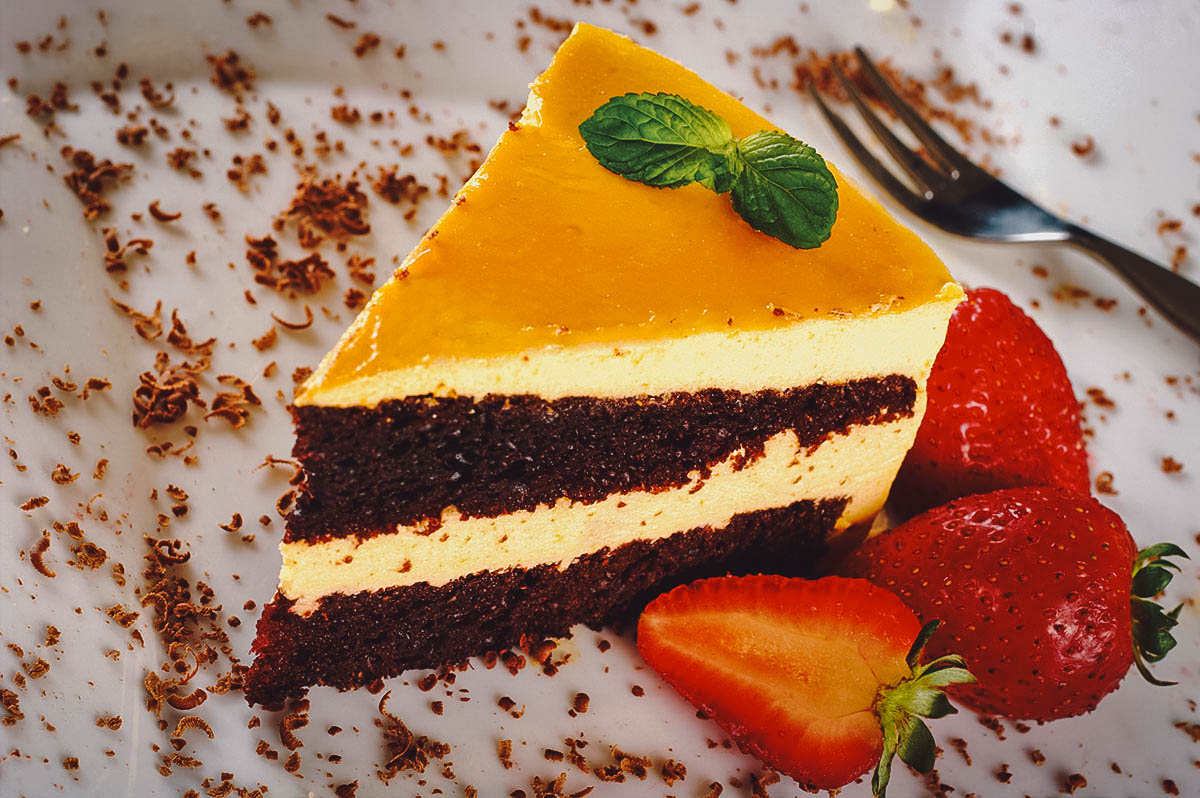 A slice of Peruvian chocolate cake with lucuma and fresh berries