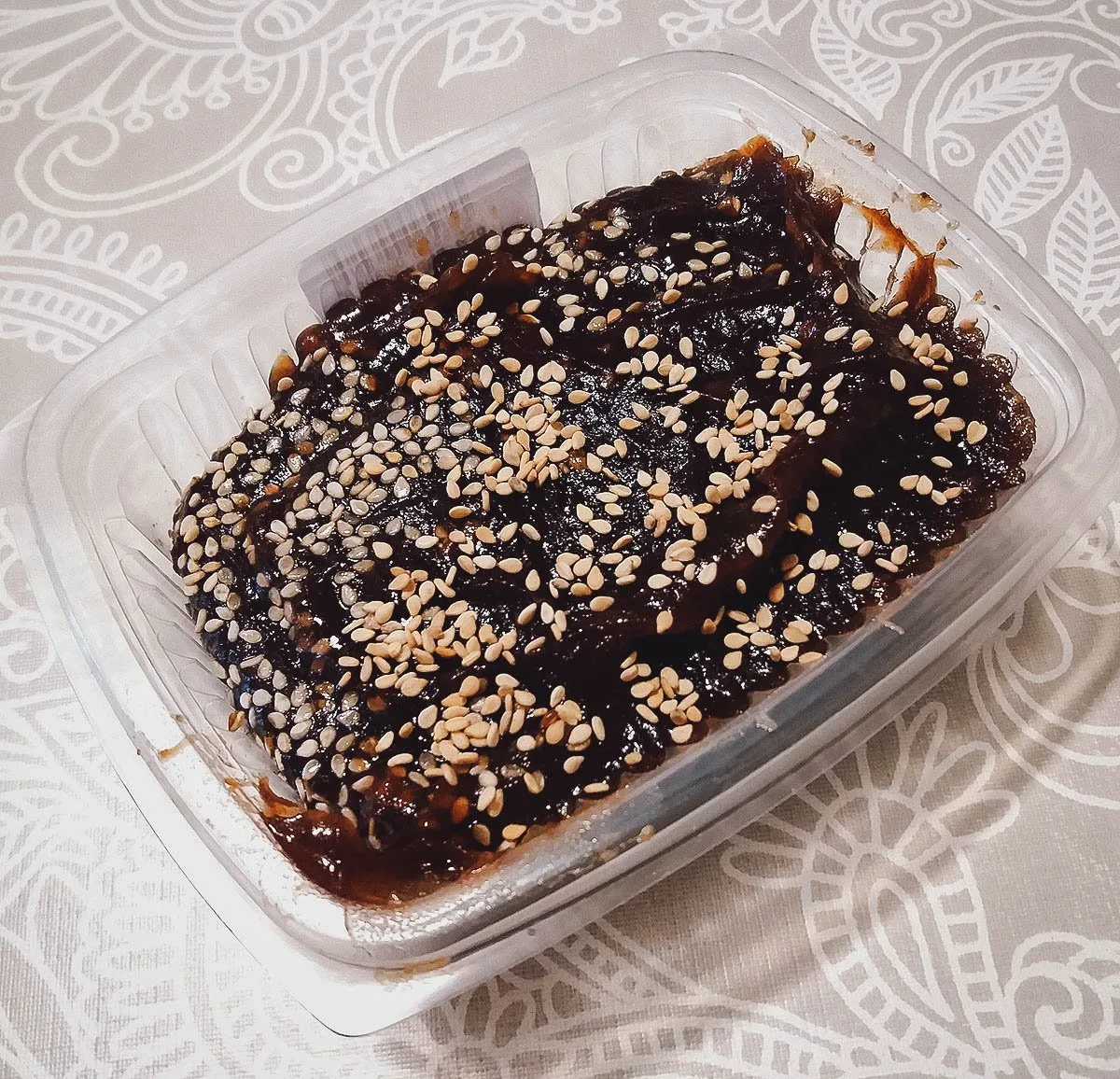 Frejol colado, a Peruvian sweetened black bean dessert topped with toasted sesame seeds