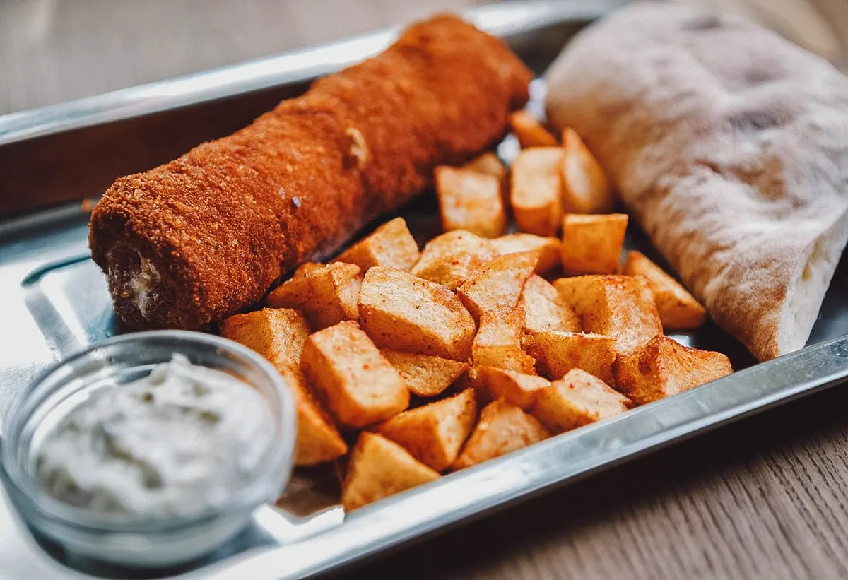 Serbian meat roll stuffed with cheese an served with potatoes and tartar sauce