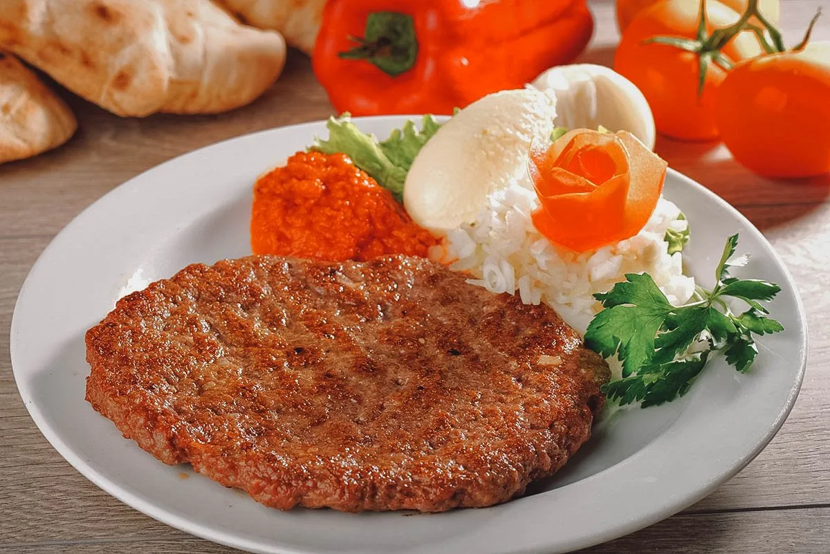 Pljeskavica or Serbian hamburger served on a plate