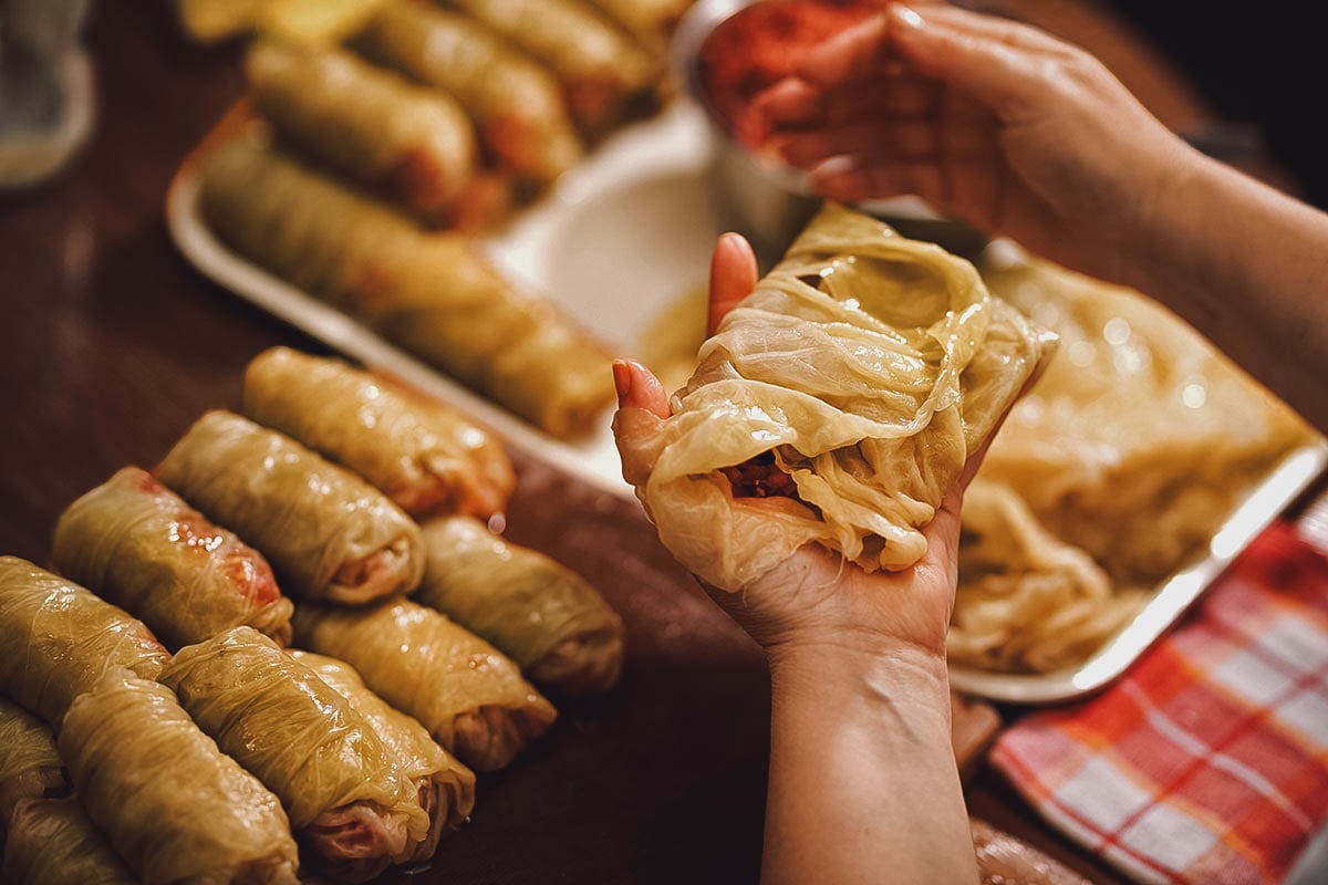 Woman preparing sarma or Serbian stuffed cabbage rolls