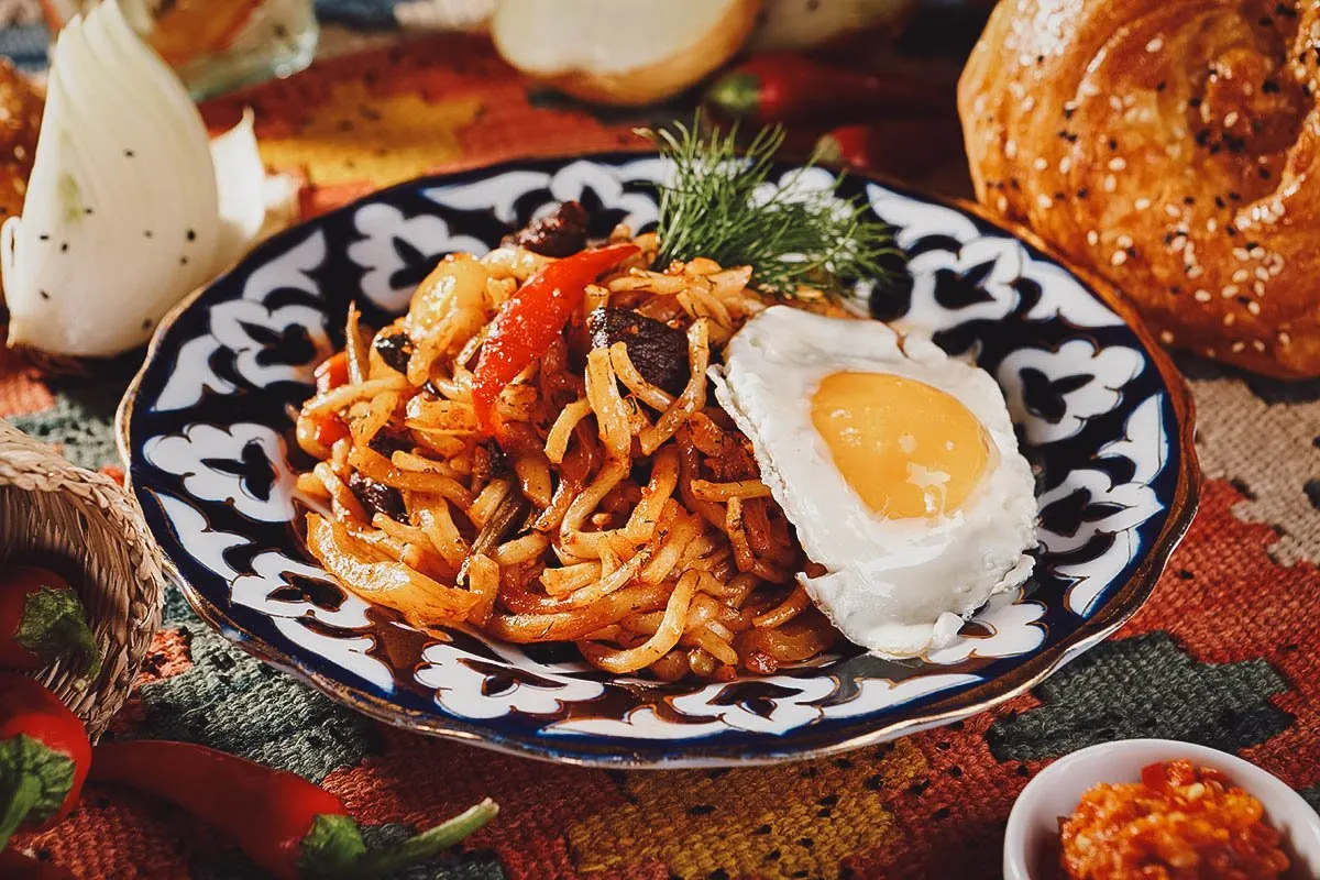 Fried lagman topped with a fried egg in Uzbekistan