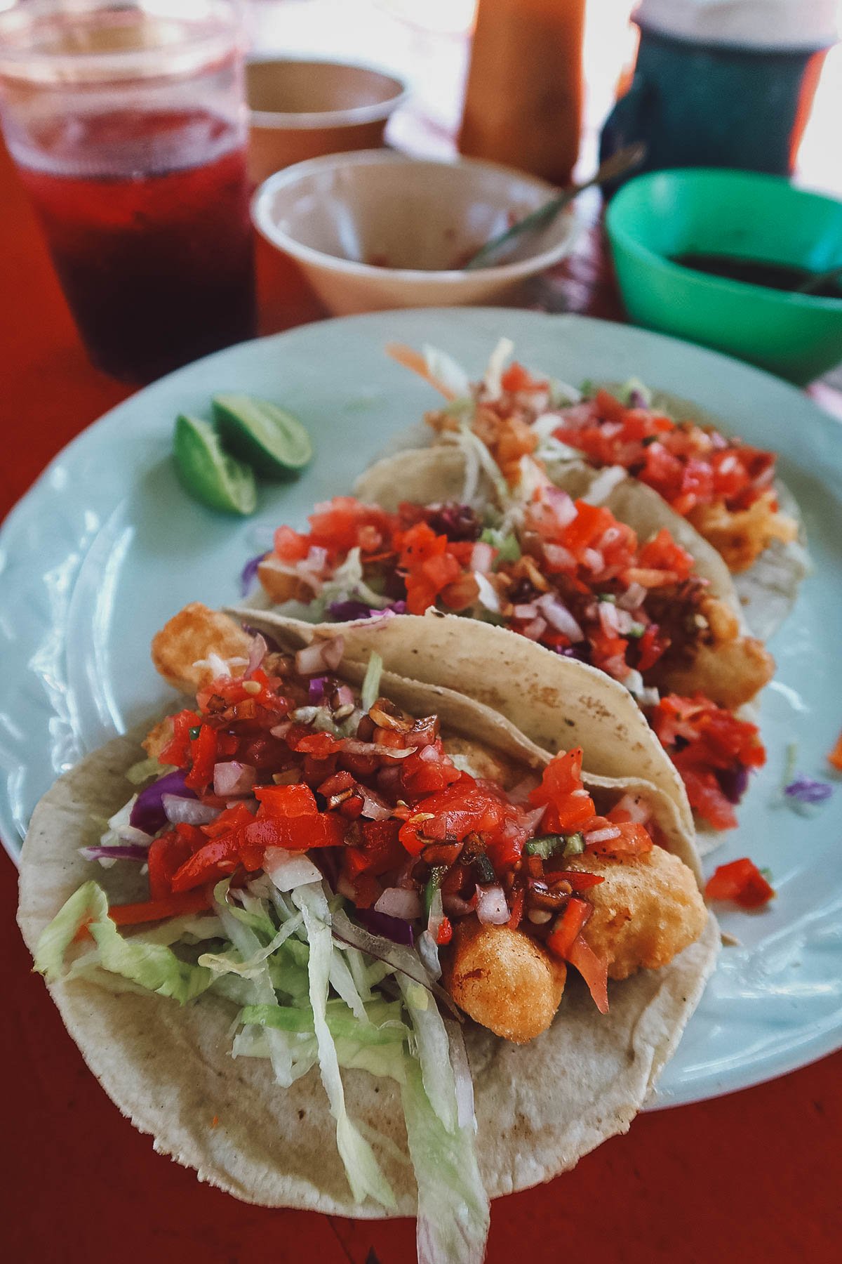 Trio of fish tacos served with pico de gallo, lettuce, and sour cream sauce