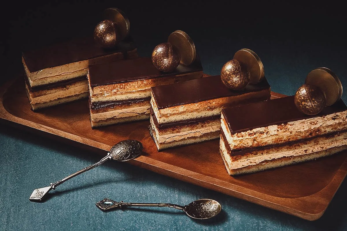Opéra cake made with layers of chocolate ganache, coffee buttercream, and almond sponge cake soaked in coffee syrup