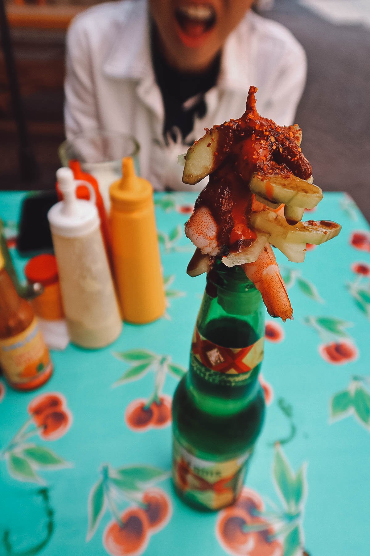 Beer bottle with skewer of shrimp at a restaurant in Guanajuato