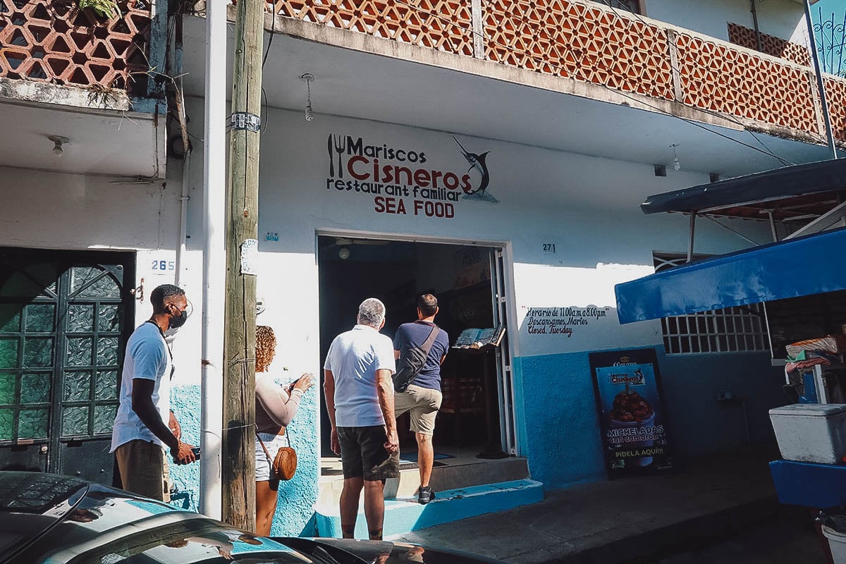 Tourists entering Mariscos Cisneros, a seafood restaurant in Puerto Vallarta