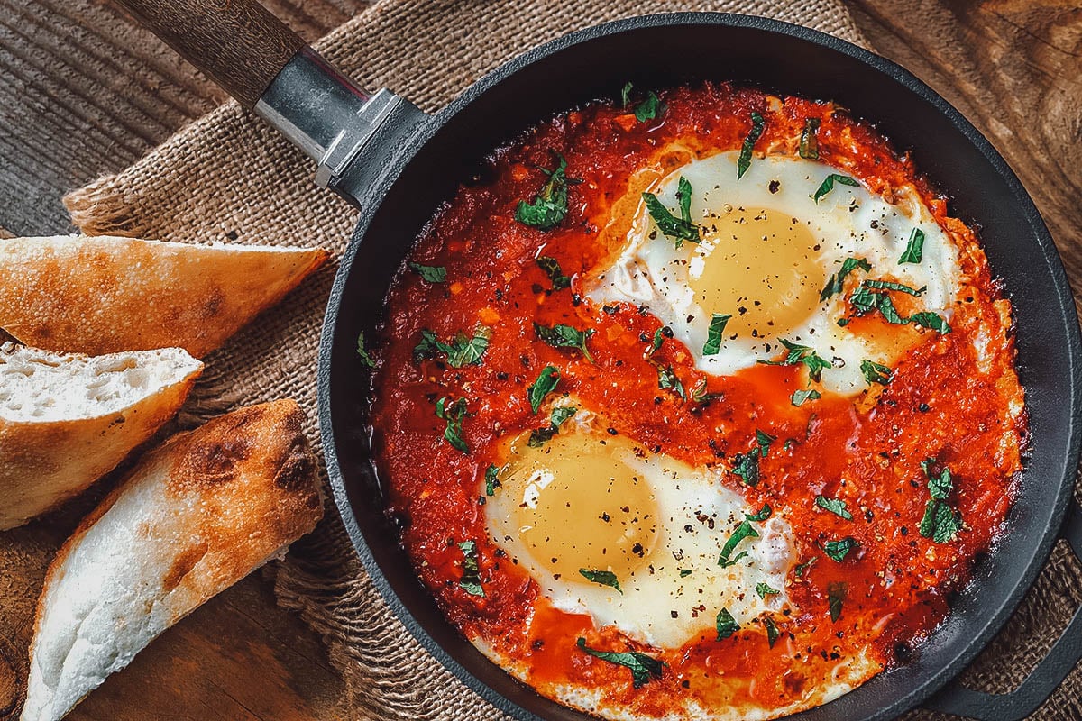 Chakchouka, a traditional Tunisian breakfast dish made with eggs poached in a spicy tomato sauce