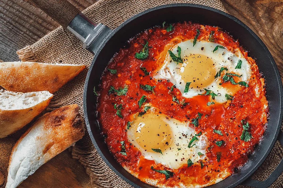 Chakchouka, a traditional Tunisian breakfast dish made with eggs poached in a spicy tomato sauce