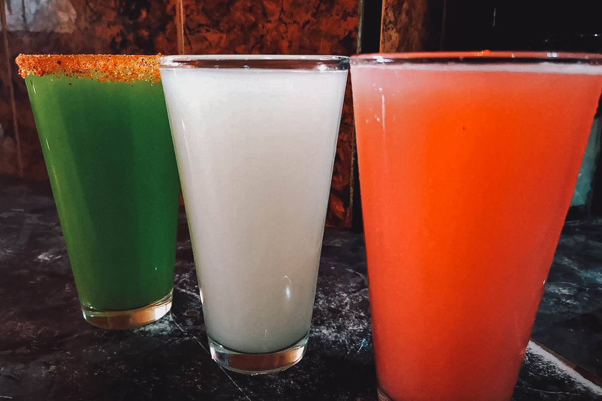 Three glasses of cocktails in the colors of the Mexican flag