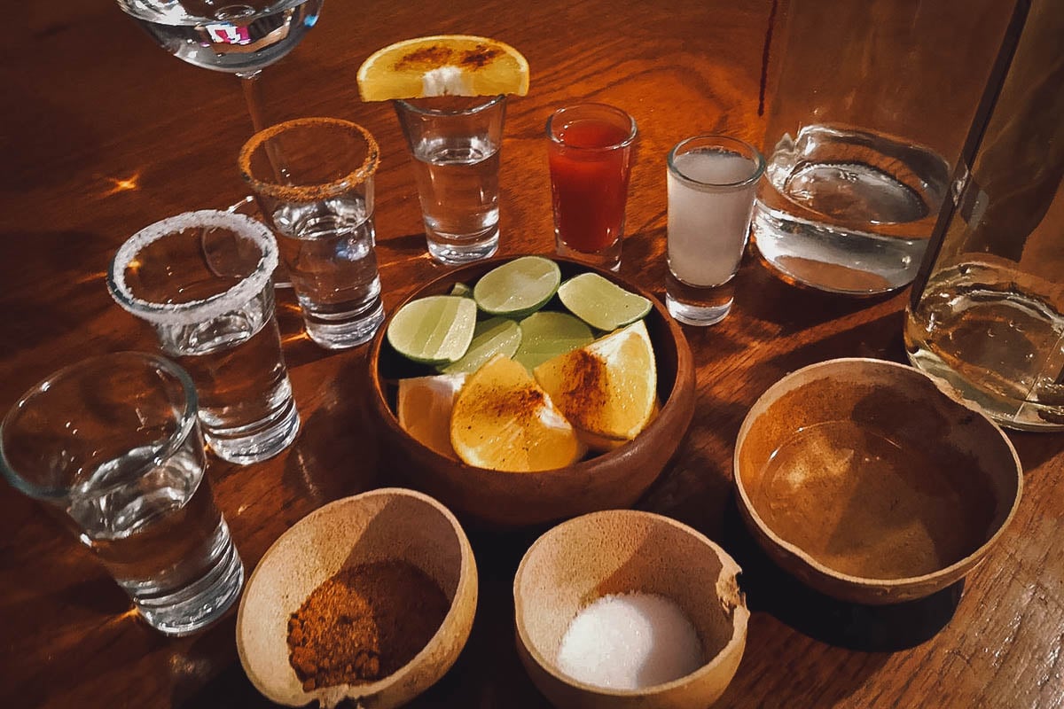 Tequila shots and other Mexican spirits with salt, chili, and orange slices