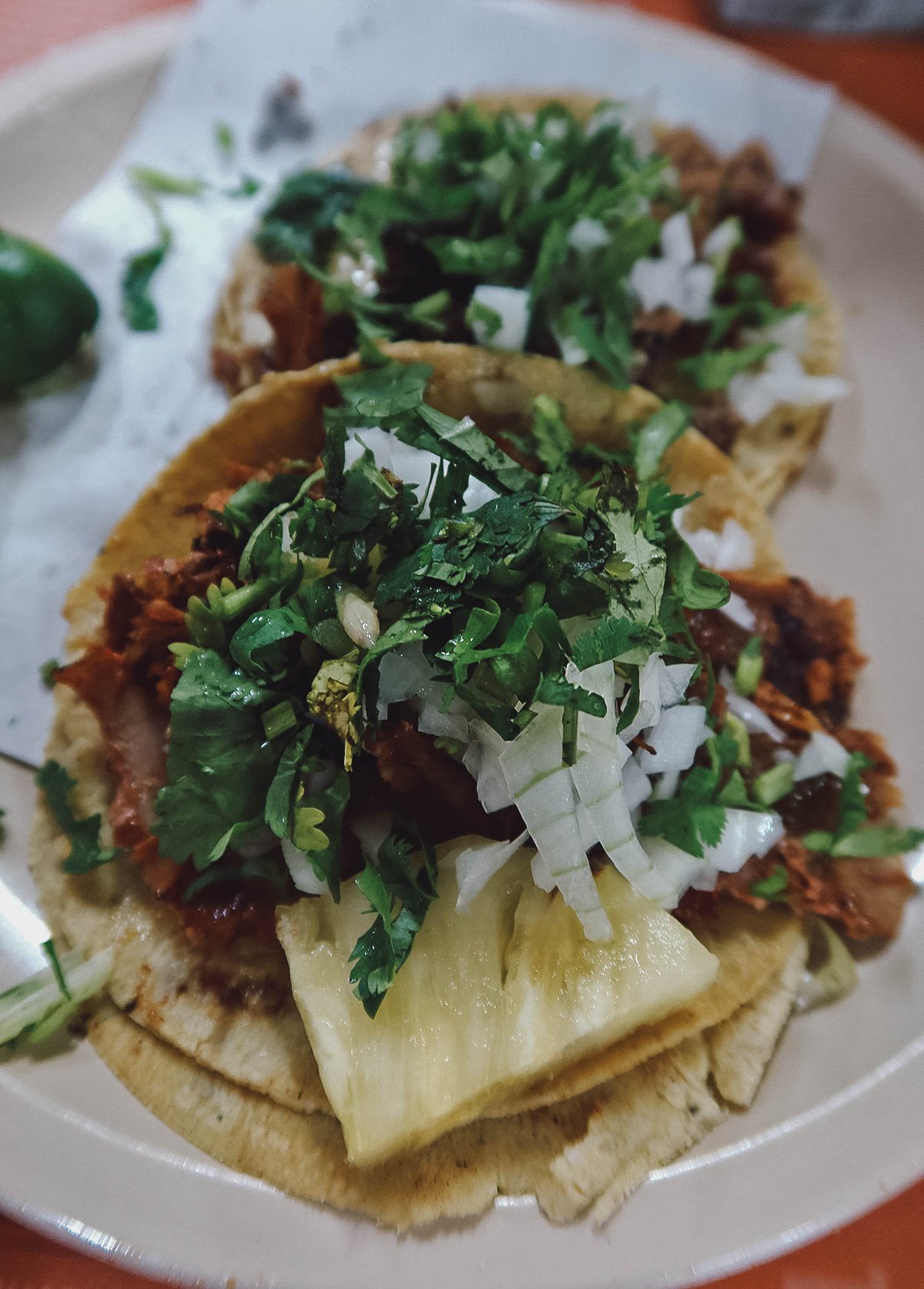 Tacos al pastor topped with everything