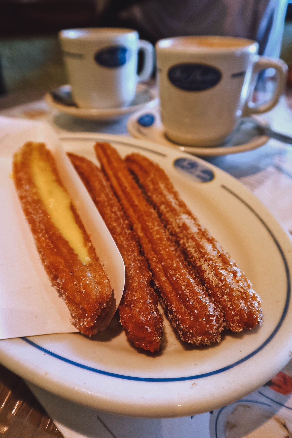 Regular and stuffed churros with hot chocolate