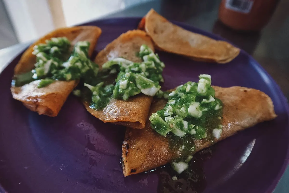 Tacos de canasta topped with salsa verde
