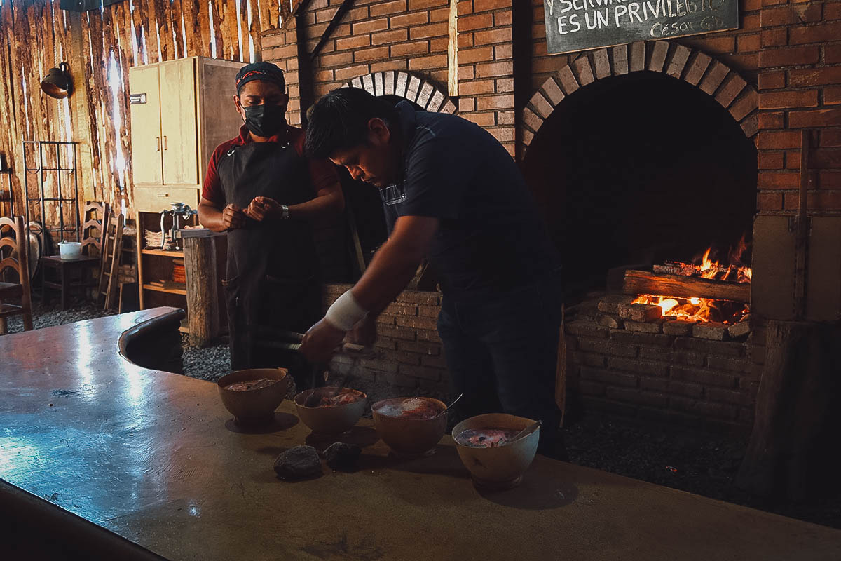 Heating river stones at Caldo de Piedra restaurant in Oaxaca