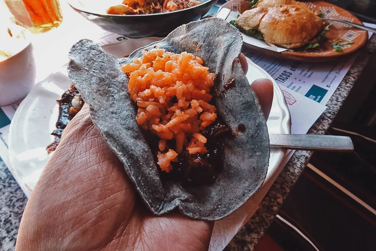 Mole and red rice in a tortilla
