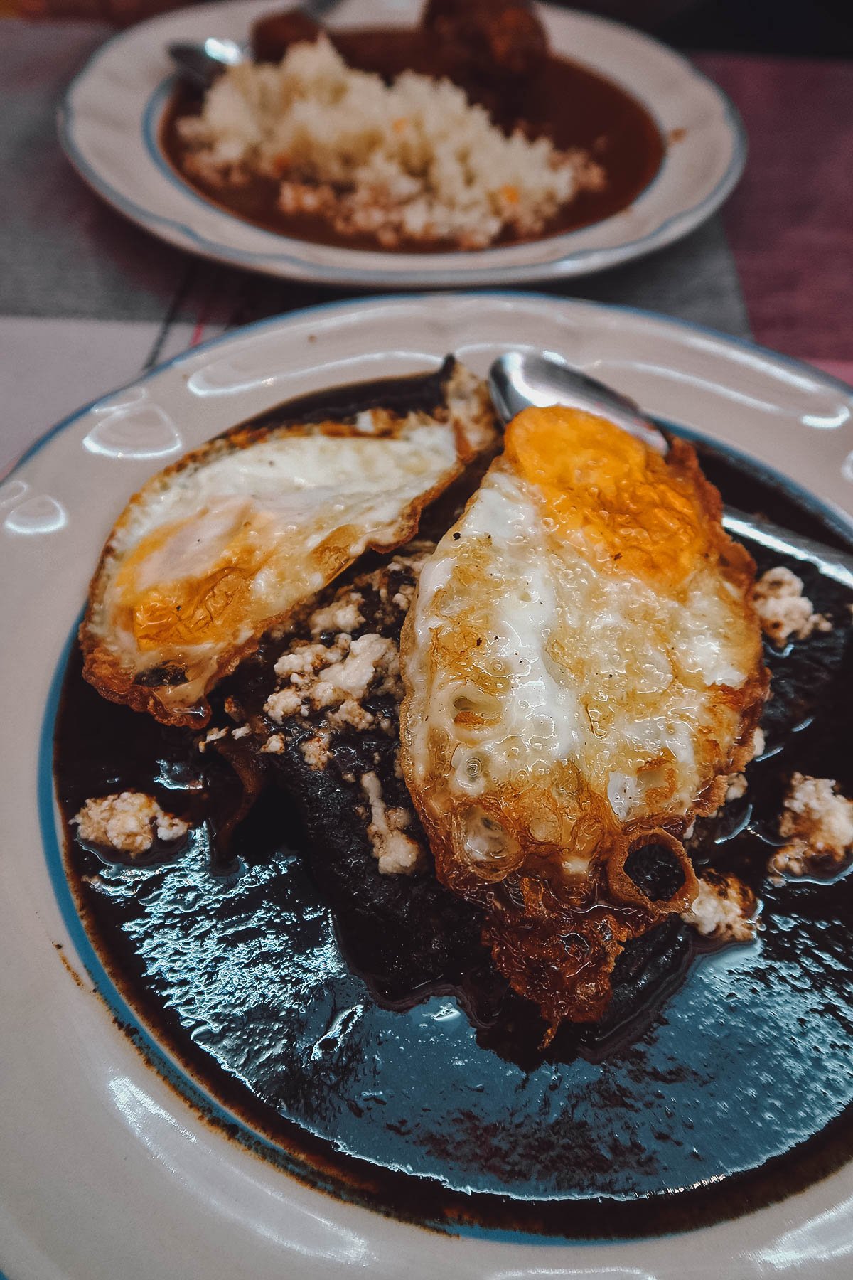 Enmoladas topped with fried eggs