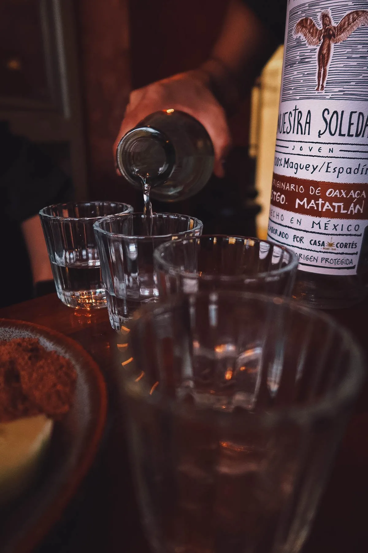Oaxacan Food Pouring shots of mezcal