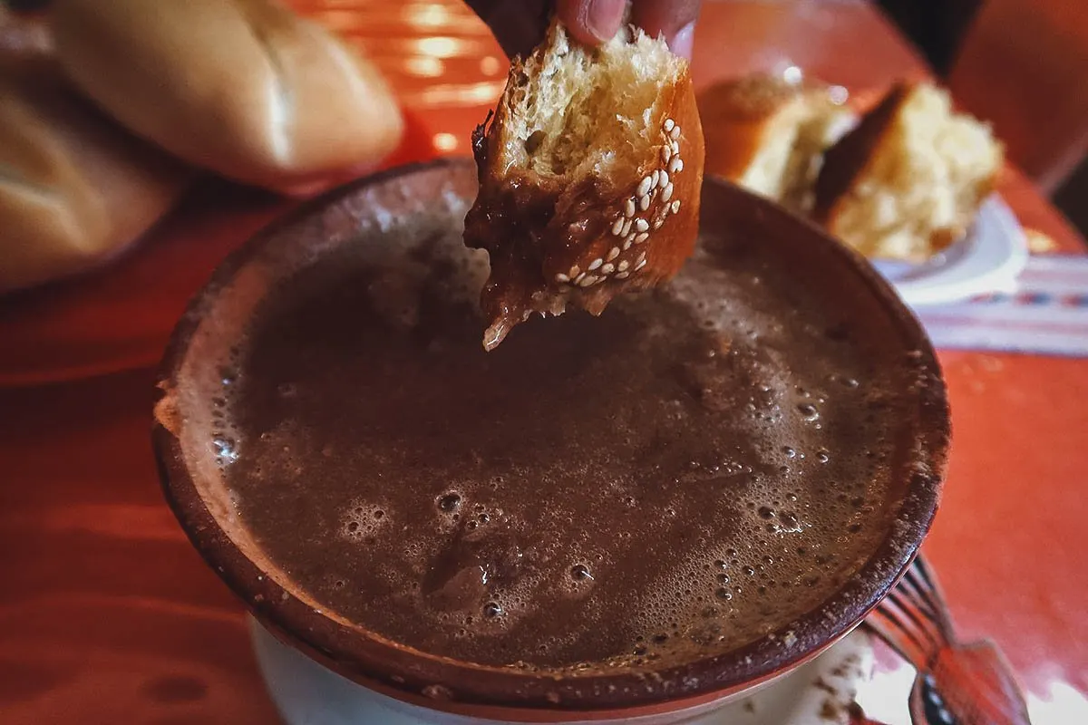 Oaxacan Food Dunking pan de yema in chocolate Oaxaqueño