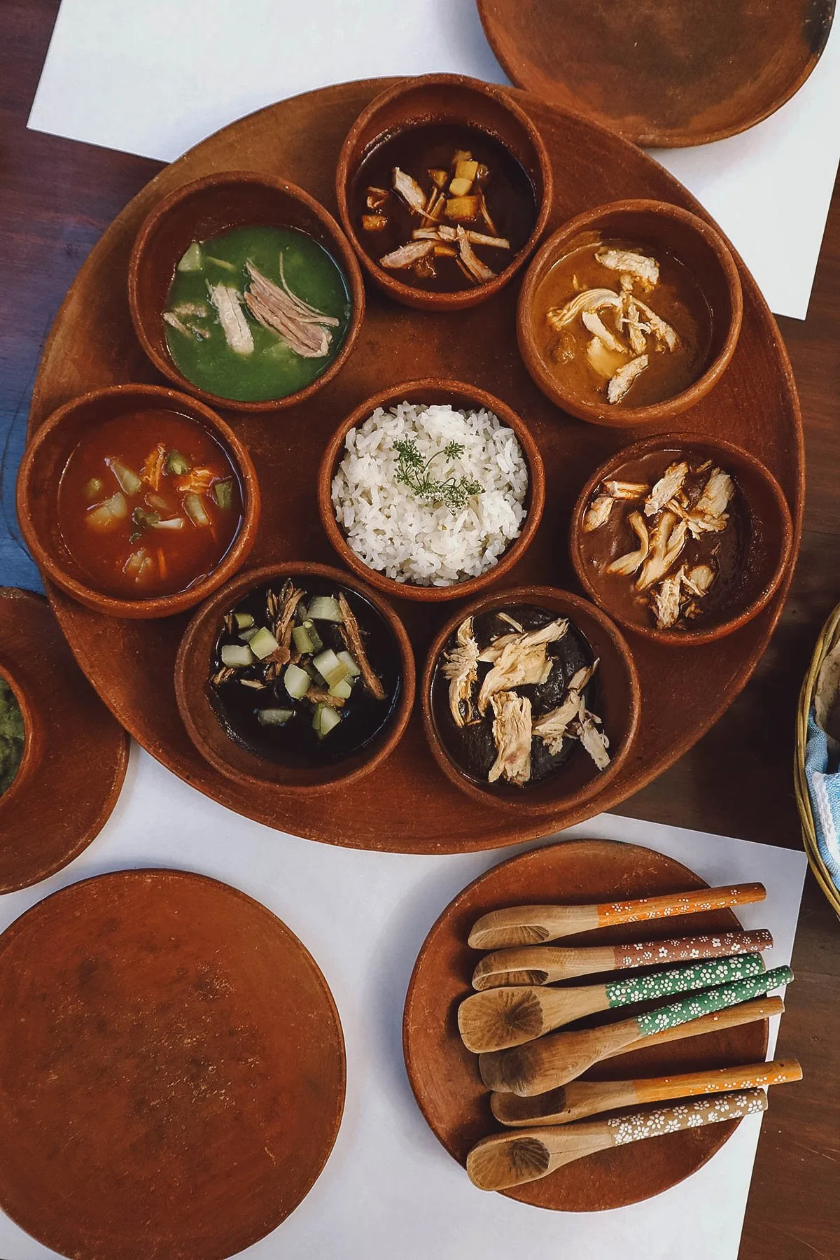 Seven Oaxacan moles with wooden spoons