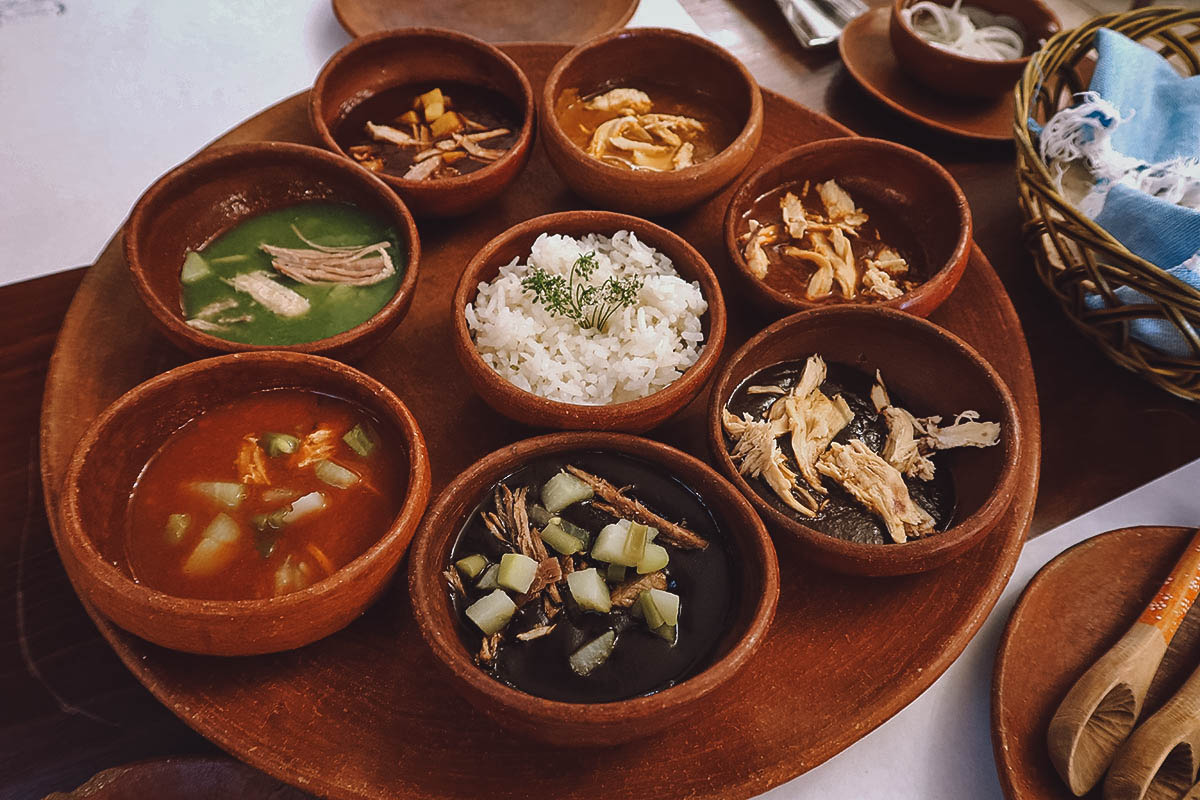 7 moles of Oaxaca topped with shredded chicken