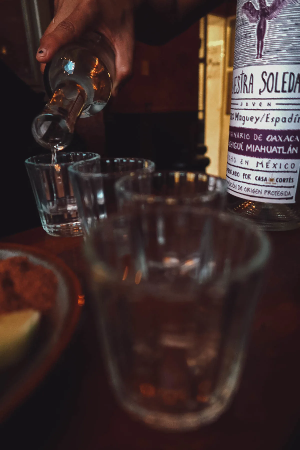 Bartender pouring drinks at Mezcalogia