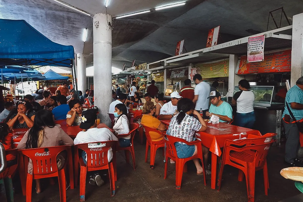 Food stalls with plastic tables and chairs in Merida