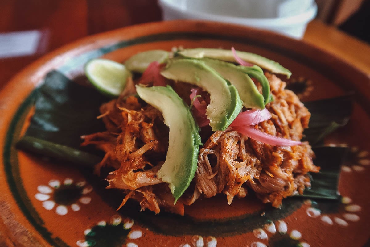 Cochinita pibil with avocado and pickled red onions