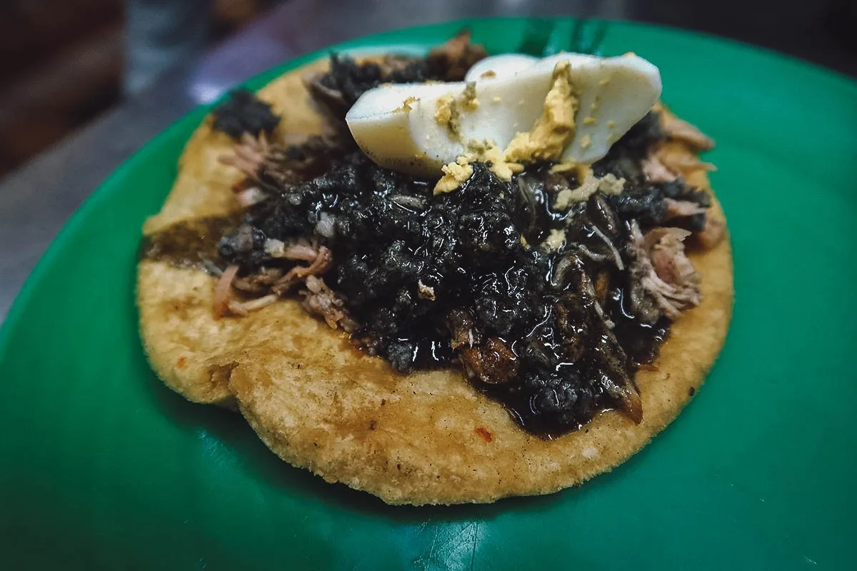 Relleno negro salbut with a hard-boiled egg