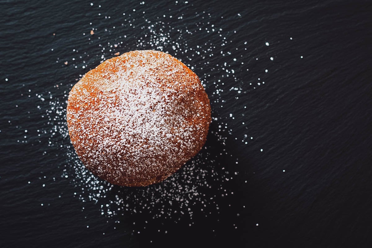 French beignet donut dusted with powdered sugar