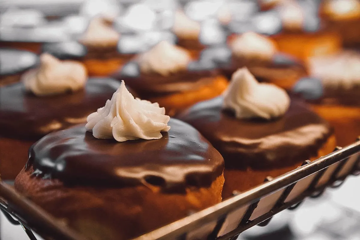 Types of Donuts From Around the World Tray of Boston cream donuts