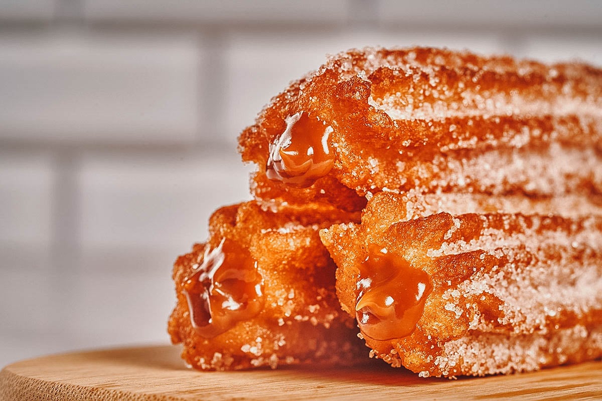 Stuffed churros coated with cinnamon sugar