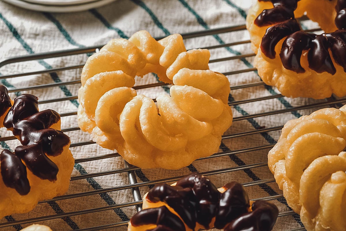 French cruller donuts topped with chocolate frosting