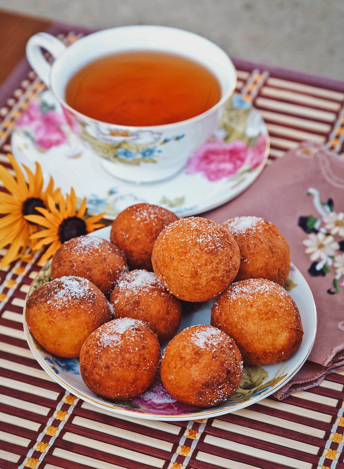 Plate of ponchiki donut holes with tea