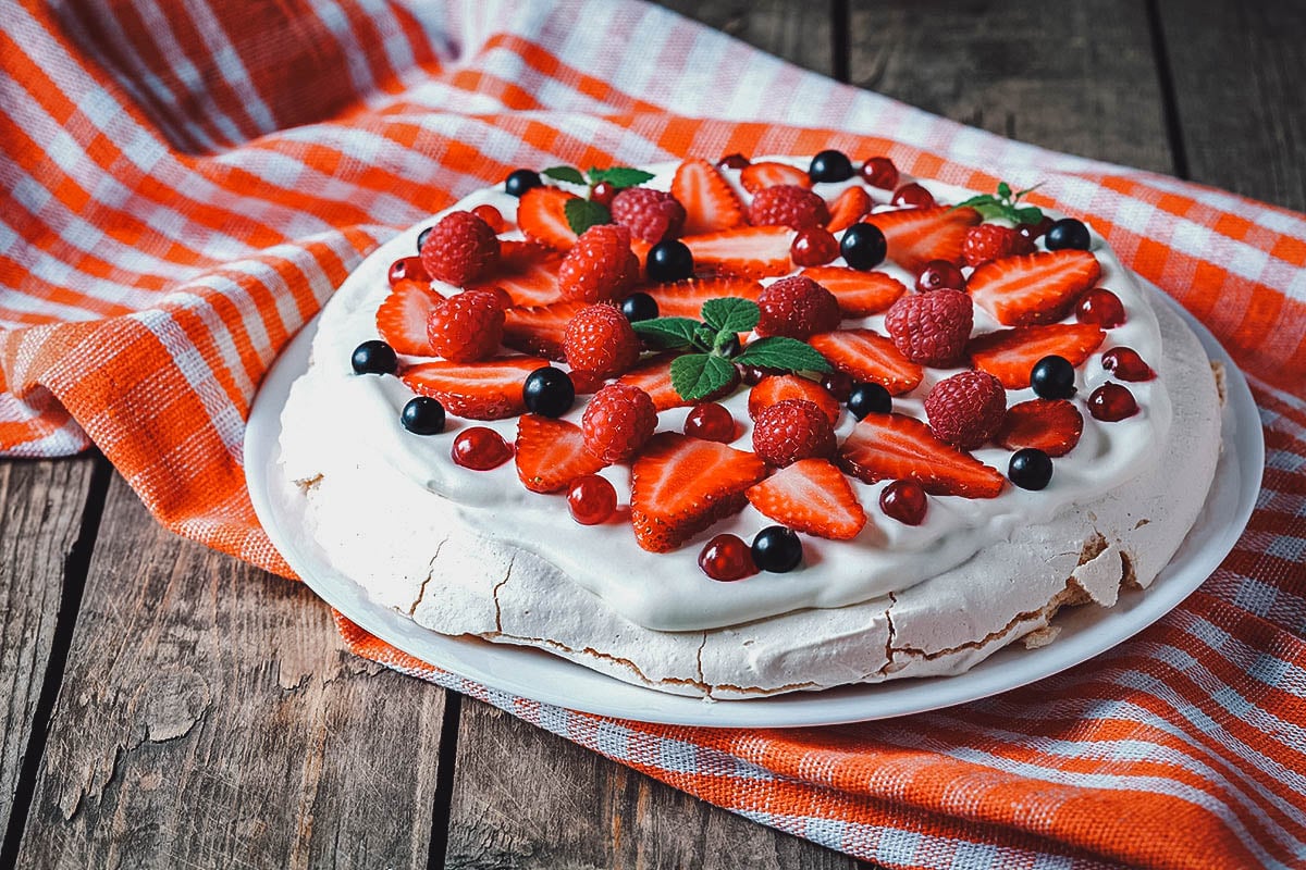 Australian pavlova topped with fresh fruit and whipped cream