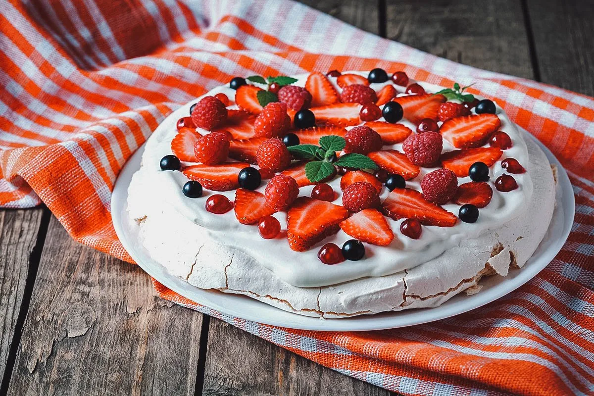 Australian Food Australian pavlova topped with fresh fruit and whipped cream