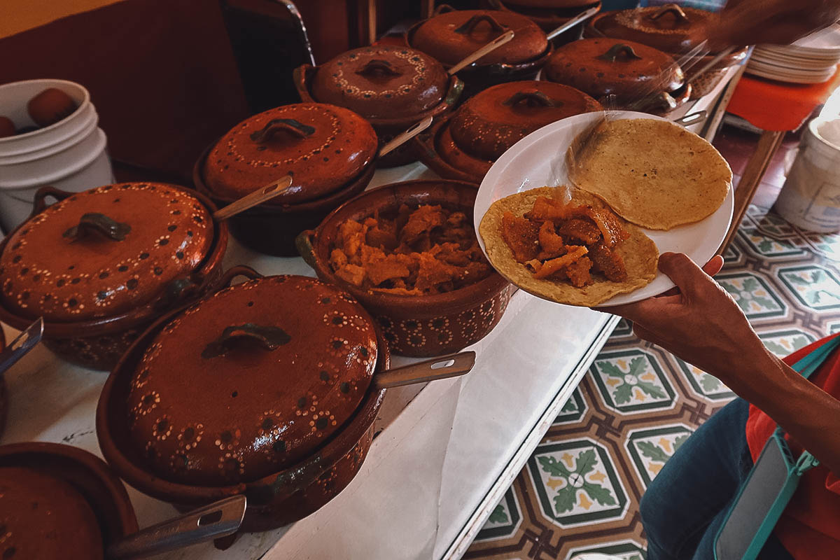 Putting guisados on tortillas at Haga Su Taco in Queretaro