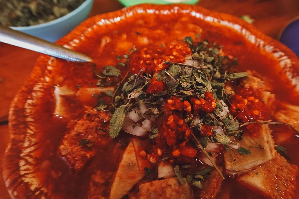 Menudo with condiments at Rico Menudo Doña Pueblito in Queretaro