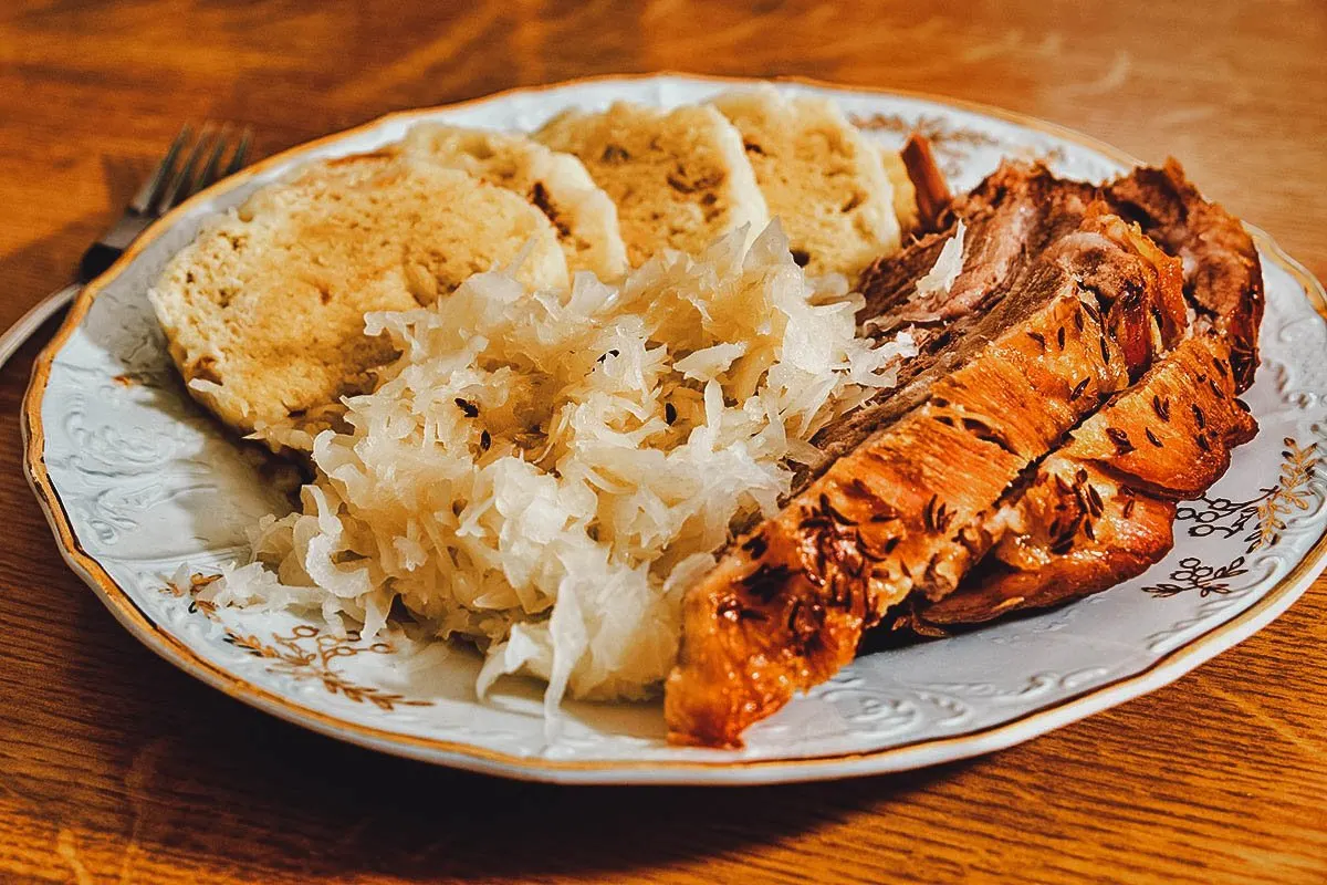 Czech Food Vepřo knedlo zelo or Czech pork roast with dumplings and sauerkraut