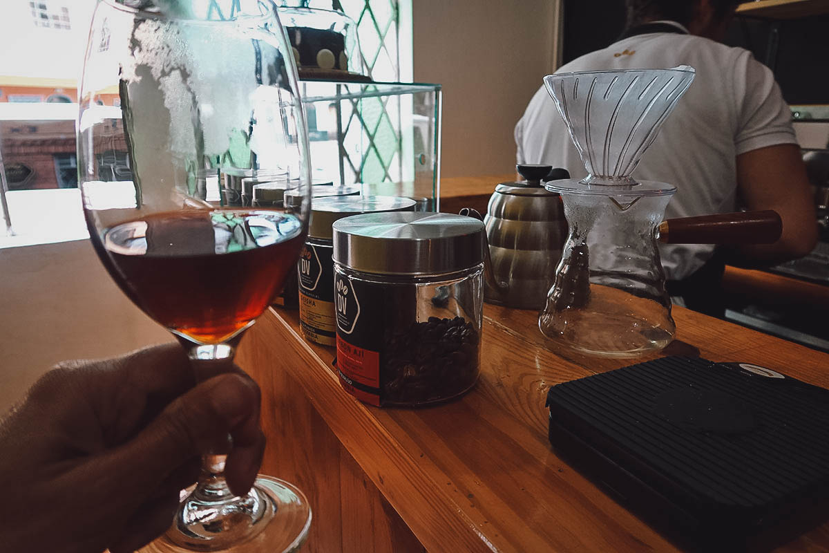 Wine glass with coffee at Divino Cafe Especial in Bogota