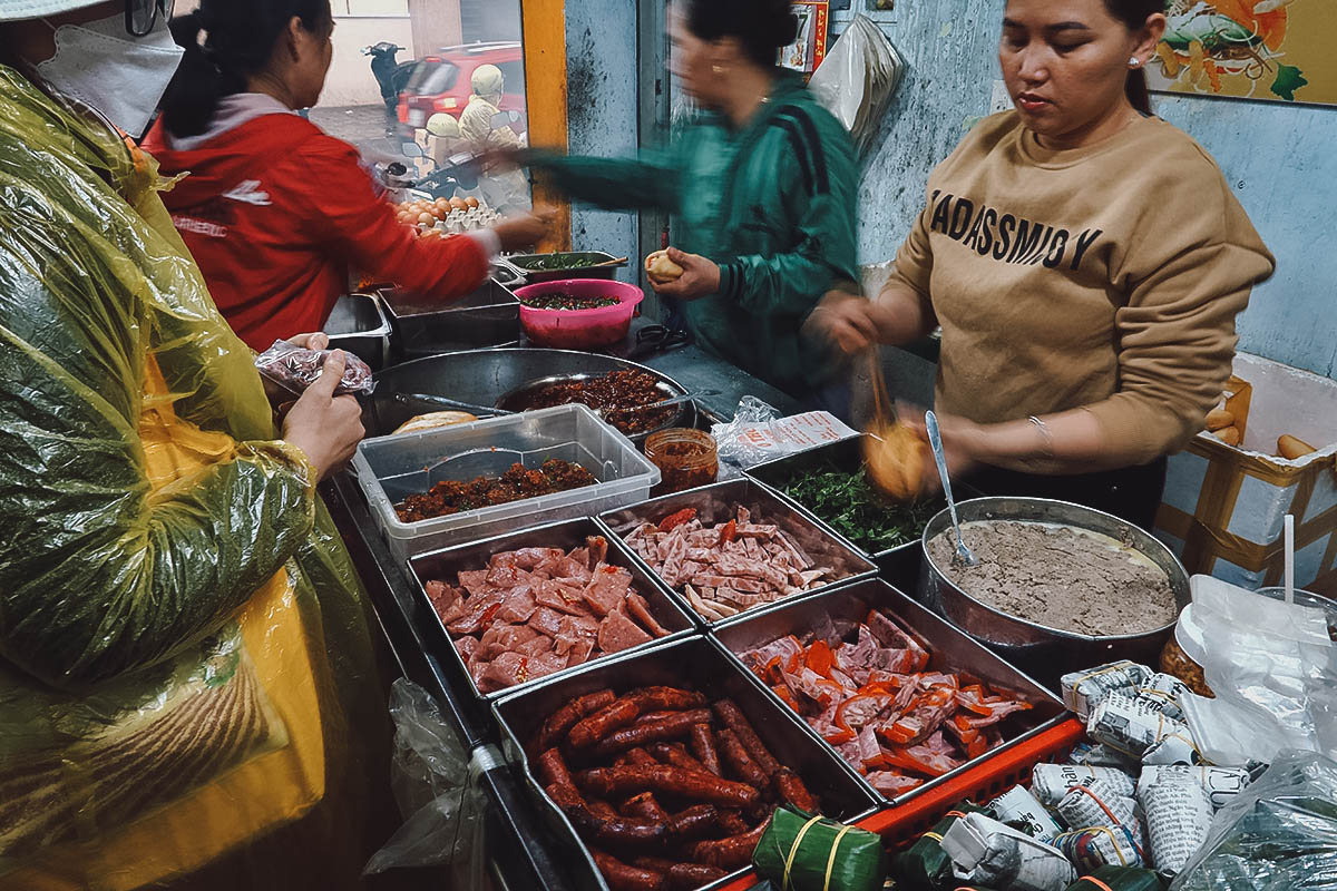 Making banh mi at O Tho restaurant in Hue, Vietnam