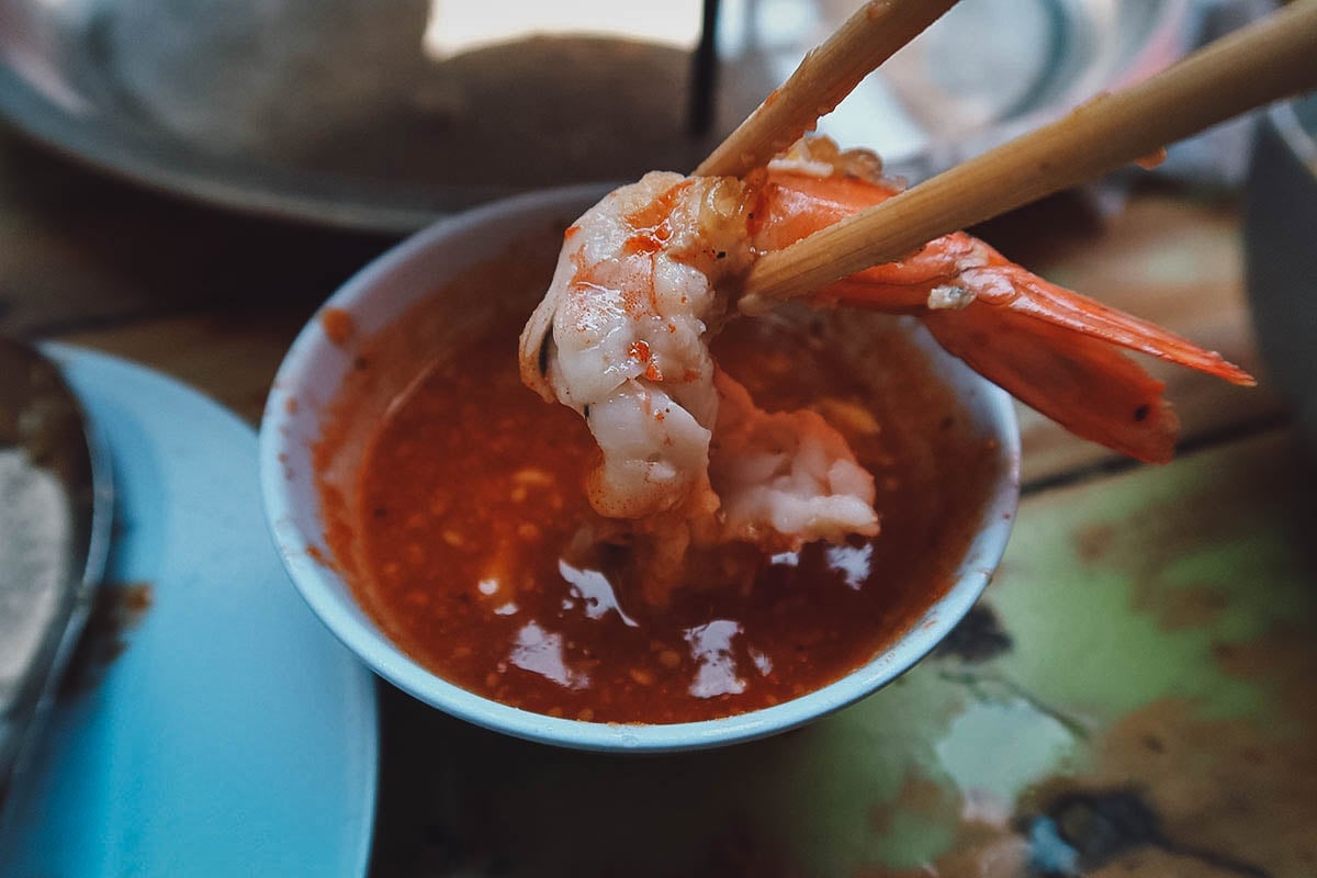 Dipping shrimp in sauce