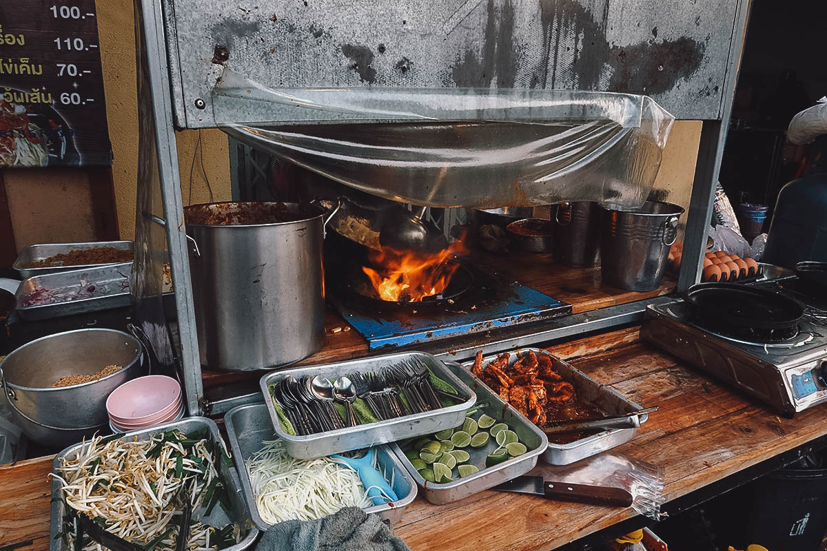 Stir-frying noodles at a street food stall in Bangkok