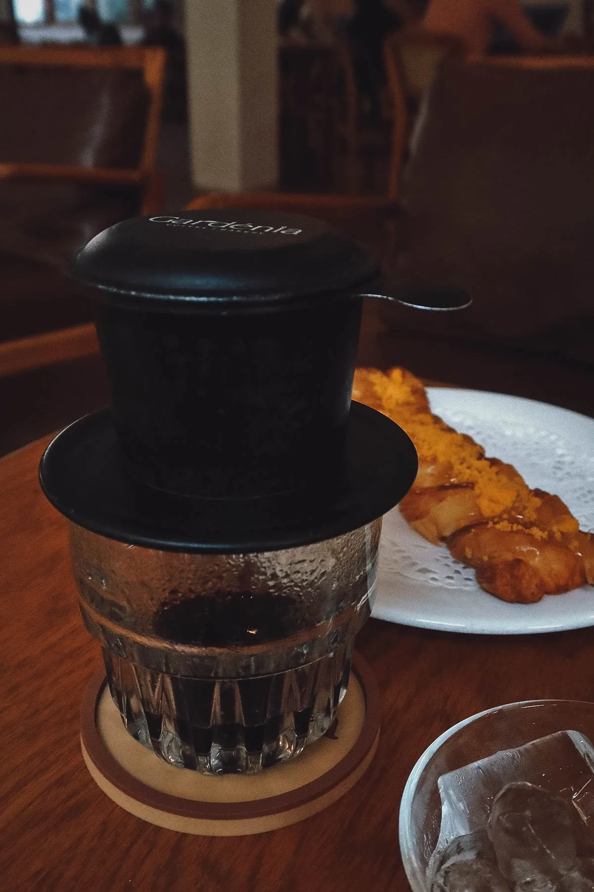Drip coffee and a pastry at a cafe in Danang, Vietnam